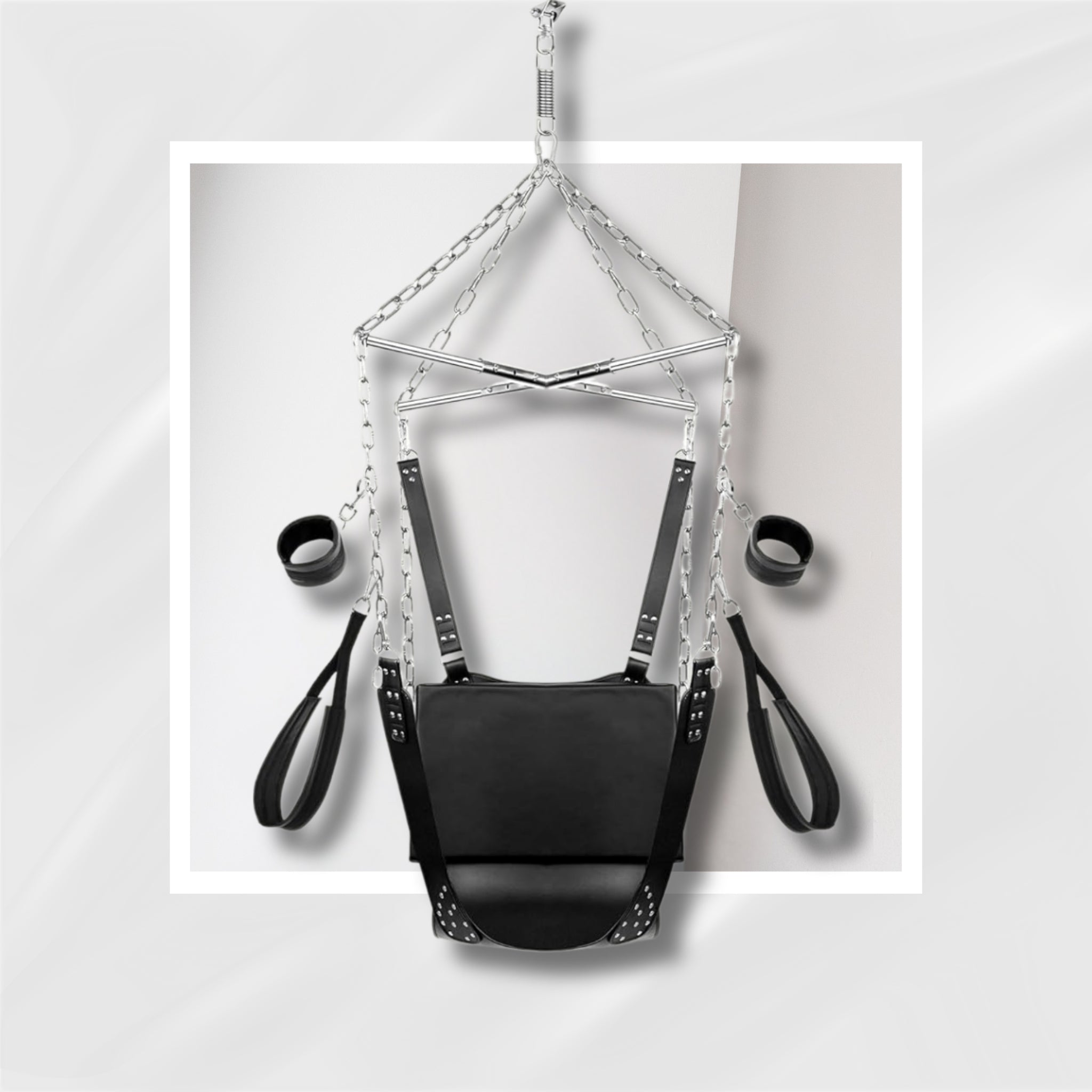 Black leather harness with chains on a light gray background