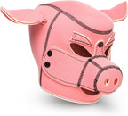 A pink faux-leather pig mask with textured panels, black contrast stitching, and small black eye studs, shown on a white background.